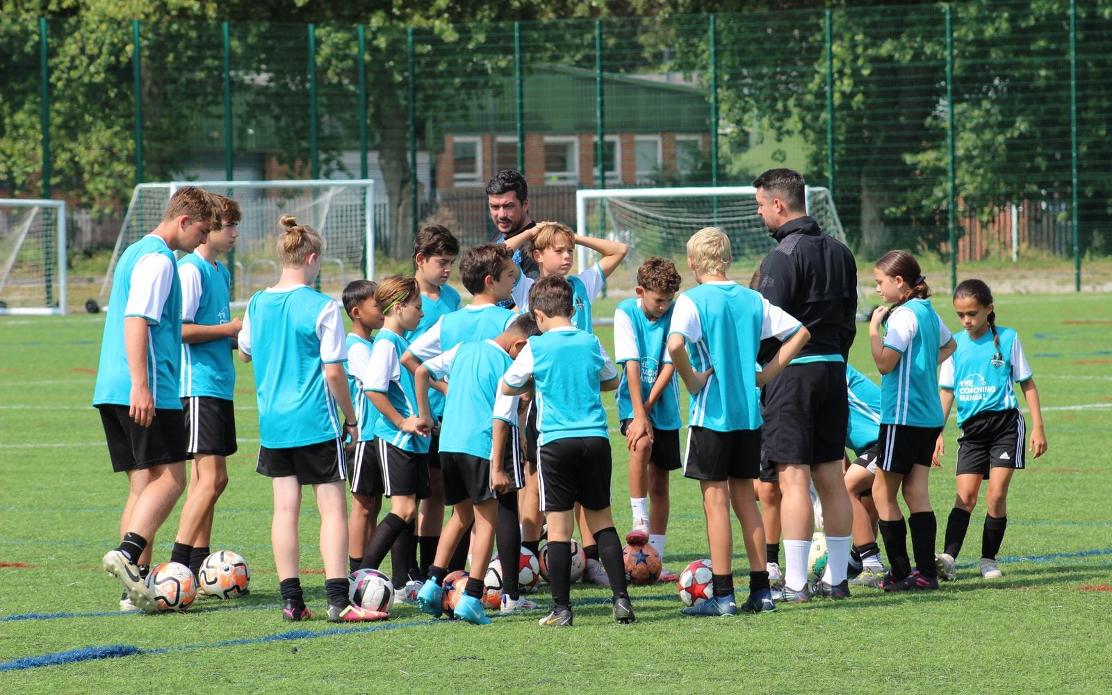 Coaching session with coach and young players
